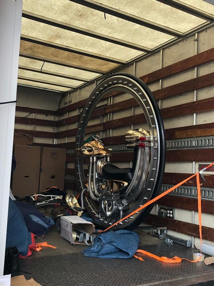 Securely strapped large commercial fitness equipment inside a moving truck during a business relocation
