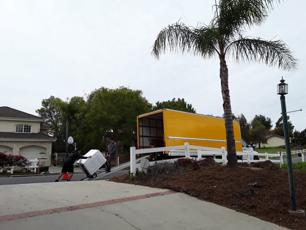 White moving truck driving on a highway, representing university student relocations in Los Angeles